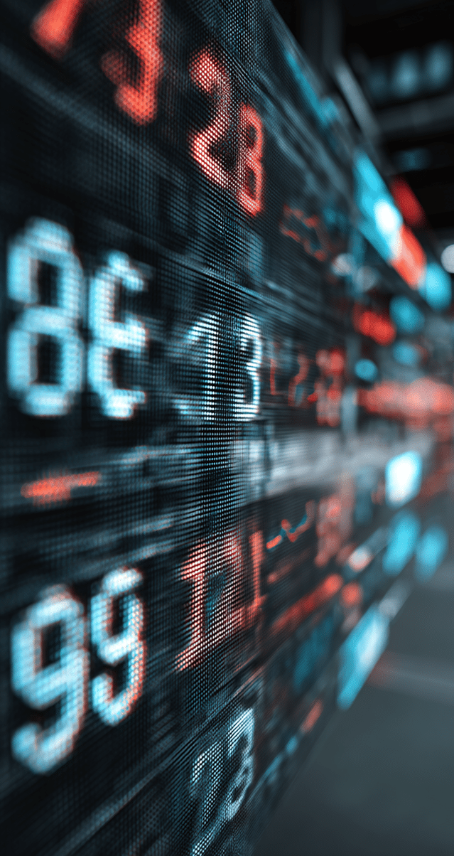A digital display board shows large, glowing numbers in red and blue, representing stock market or financial data, with the numbers slightly blurred for a dynamic effect.